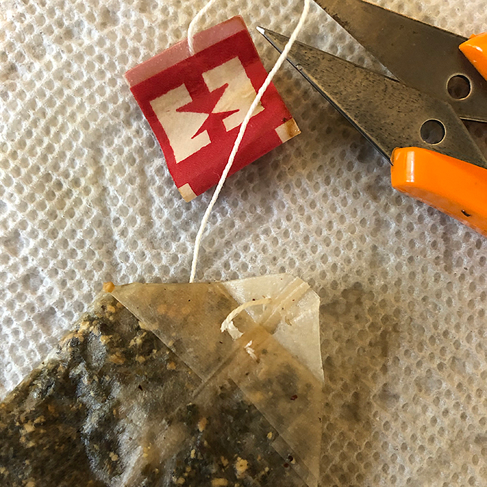Image of removing tea bag tags